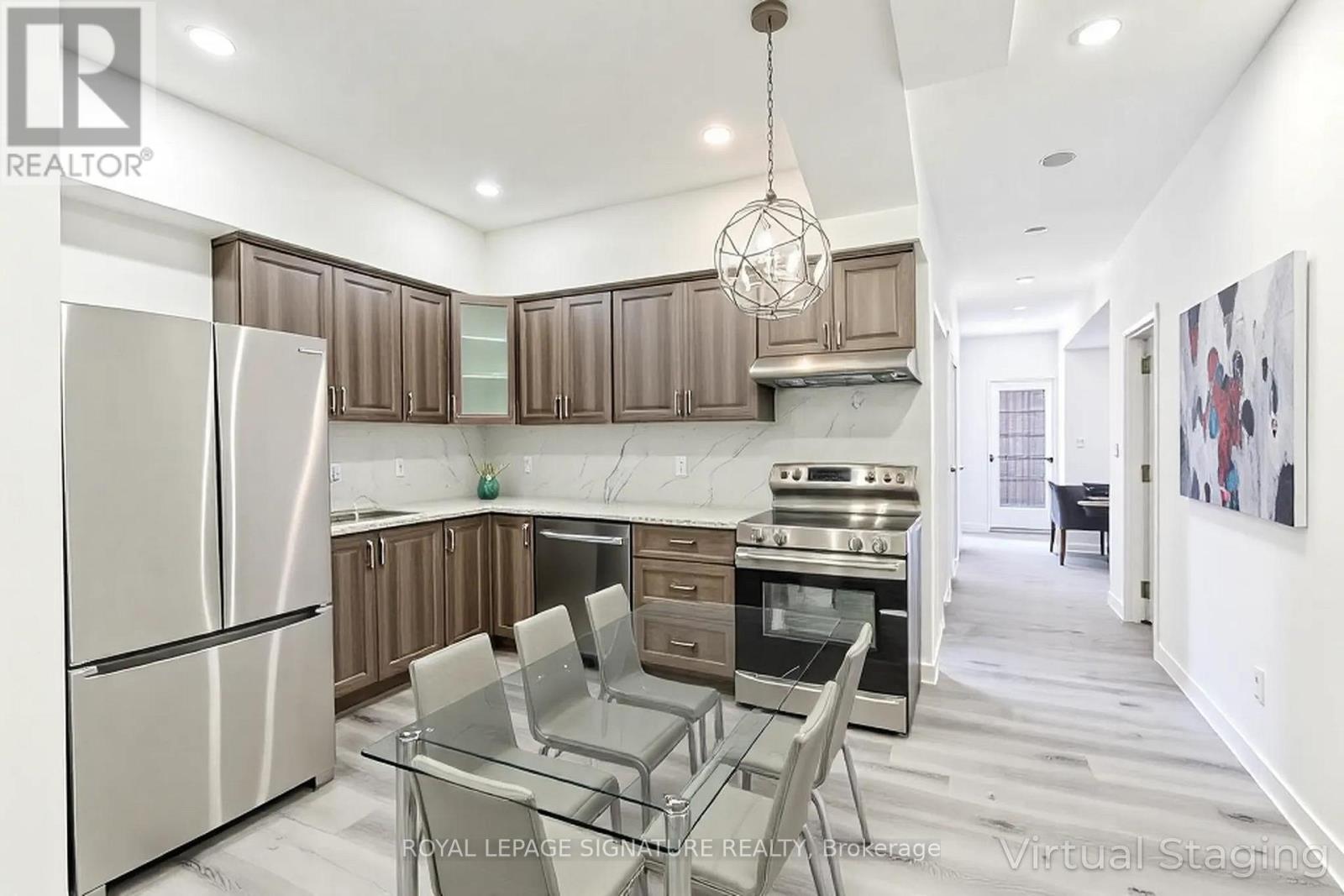 A modern kitchen with a glass table and stainless steel appliances.