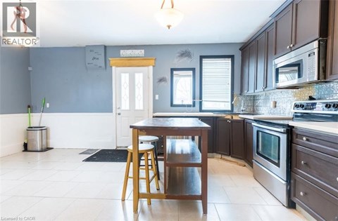 A kitchen with a table and chairs in front of a window.