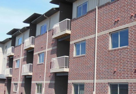 a brick building with balconies on the side of it