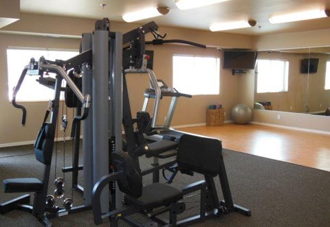 a gym with some exercise equipment in a room