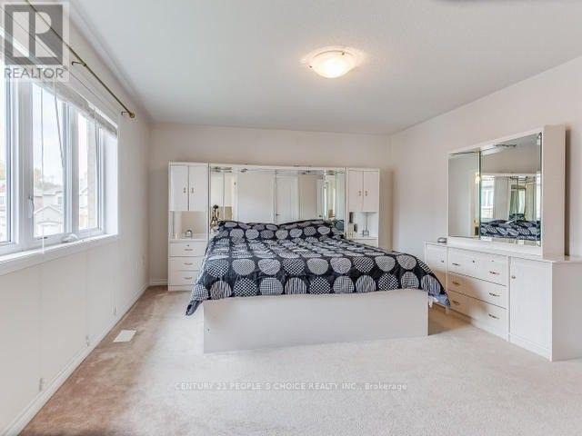 A bedroom with a bed, dresser, and mirror.