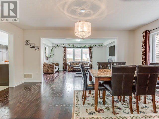 A dining room with a wooden table and chairs.
