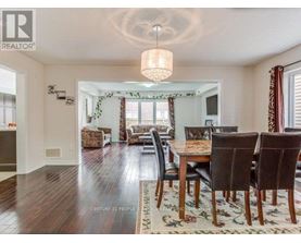 A dining room with a wooden table and chairs.