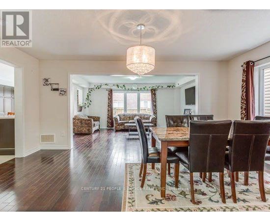 A dining room with a wooden table and chairs.