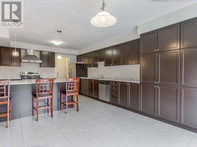 A kitchen with brown cabinets and a white ceiling.