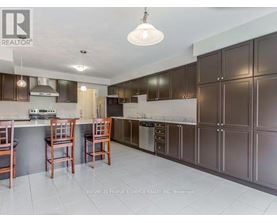 A kitchen with brown cabinets and a white ceiling.