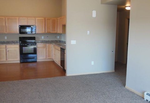 a kitchen with wooden cabinets and a stove and a microwave