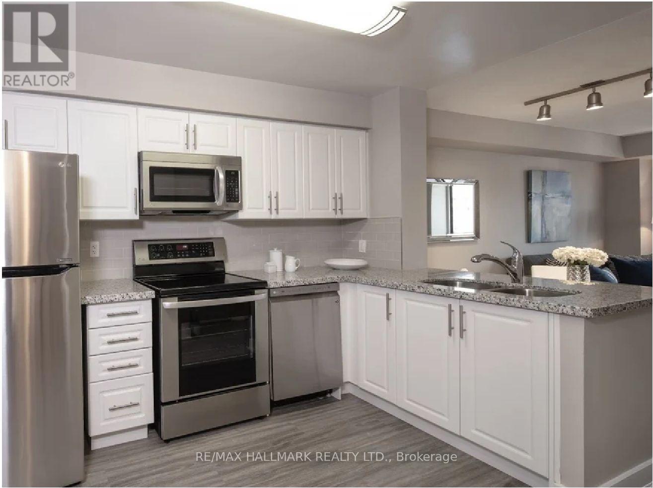 A kitchen with white cabinets and stainless steel appliances.