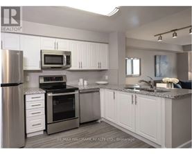 A kitchen with white cabinets and stainless steel appliances.