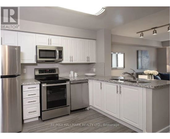 A kitchen with white cabinets and stainless steel appliances.