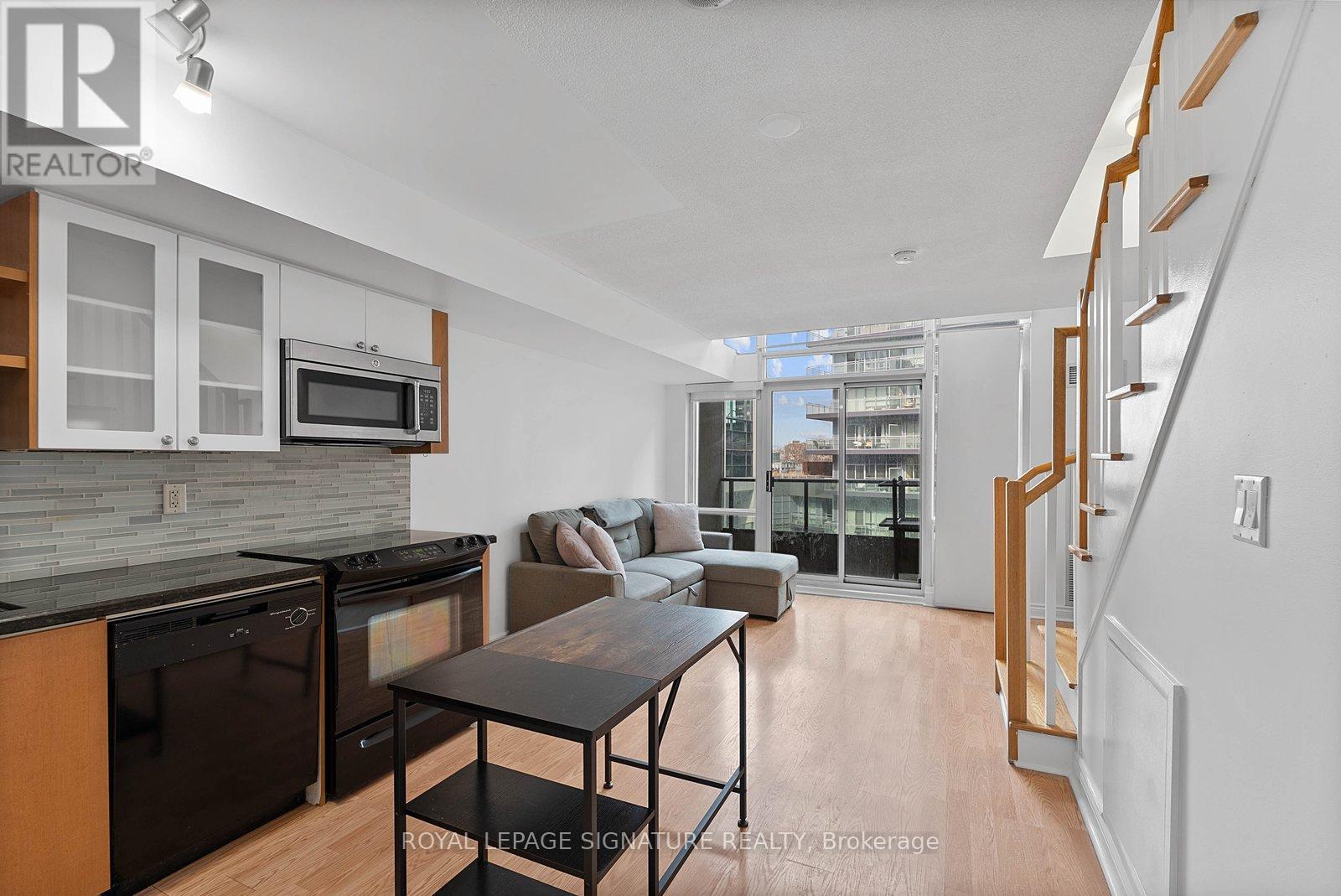 A modern kitchen with a dining table and chairs.