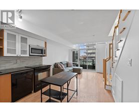 A modern kitchen with a dining table and chairs.