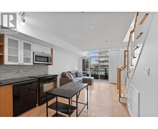 A modern kitchen with a dining table and chairs.