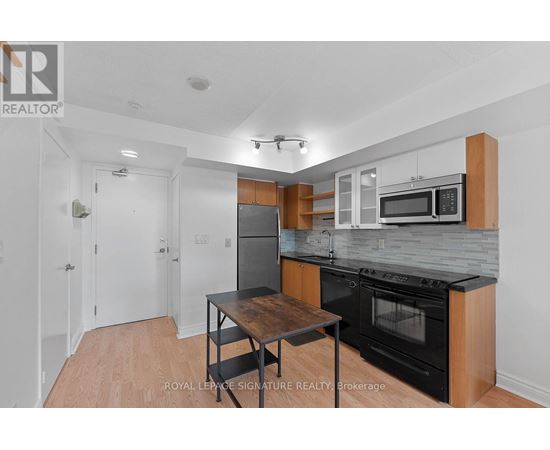 A kitchen with a table and a microwave oven.