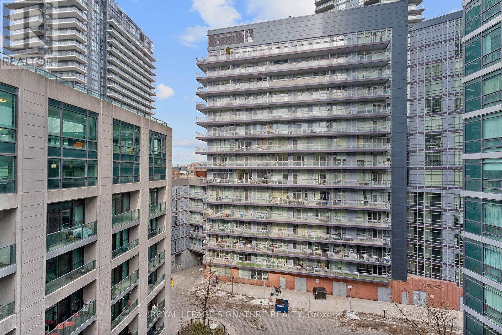 A view of a cityscape with apartment buildings and a sign that reads "ROYAL LEPRIE SIGNATURE REALTY".