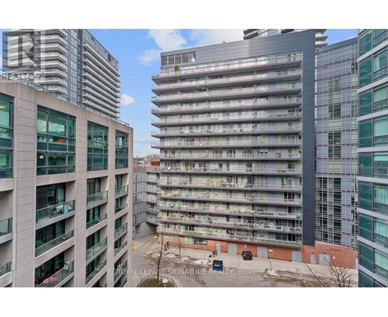 A view of a cityscape with apartment buildings and a sign that reads "ROYAL LEPRIE SIGNATURE REALTY".