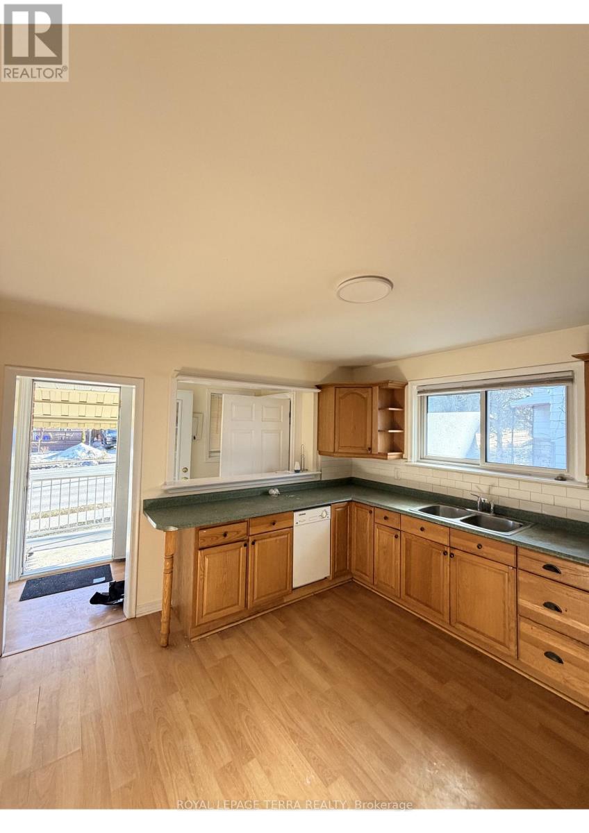 A kitchen with wooden cabinets and a washing machine.