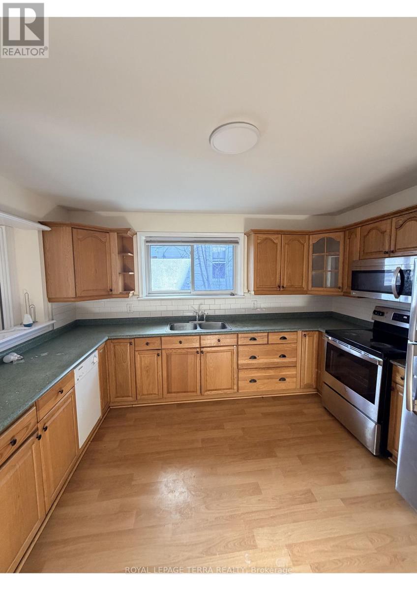 A kitchen with wooden cabinets and a green countertop.