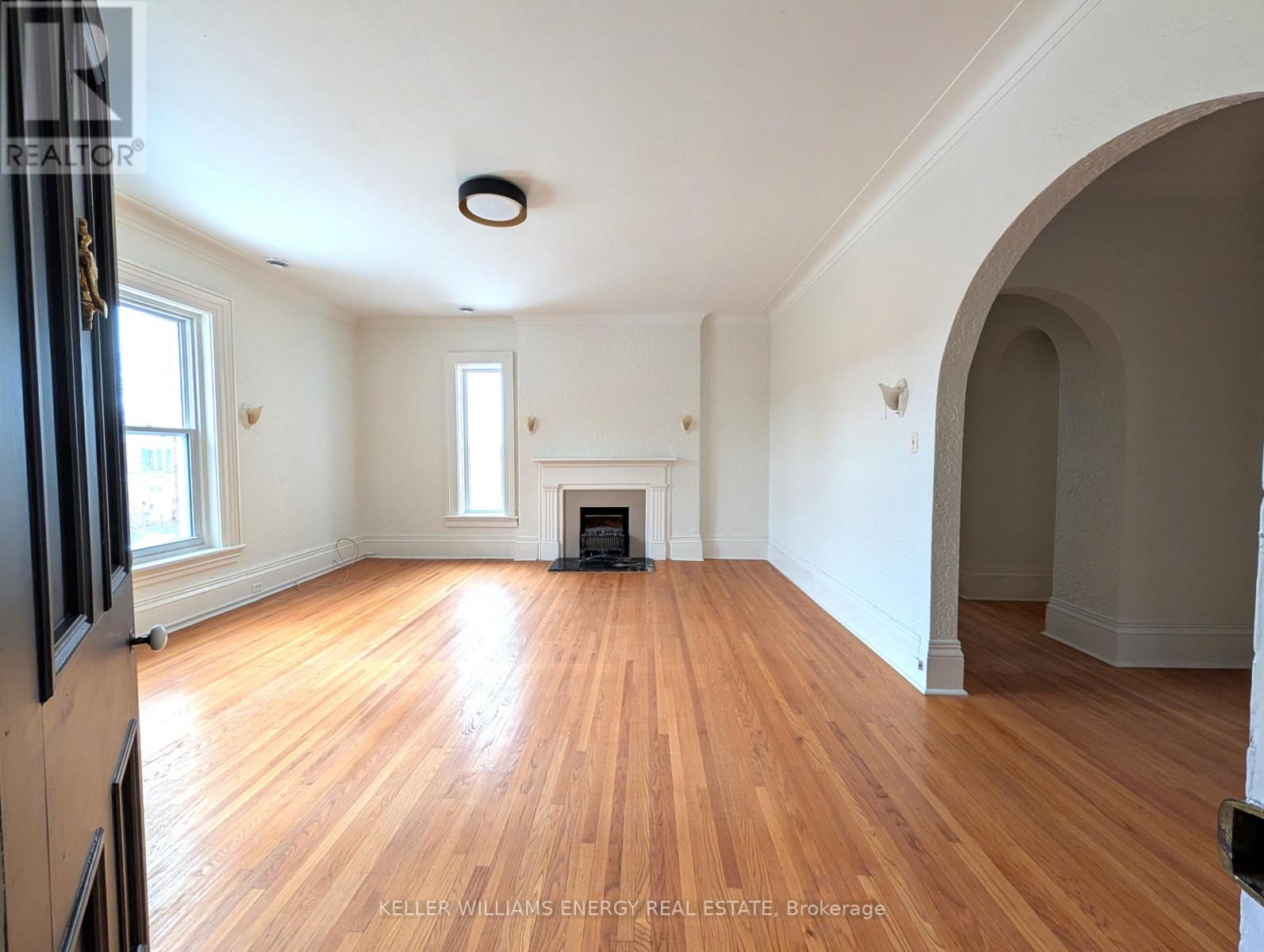 A room with wooden floors and a fireplace.
