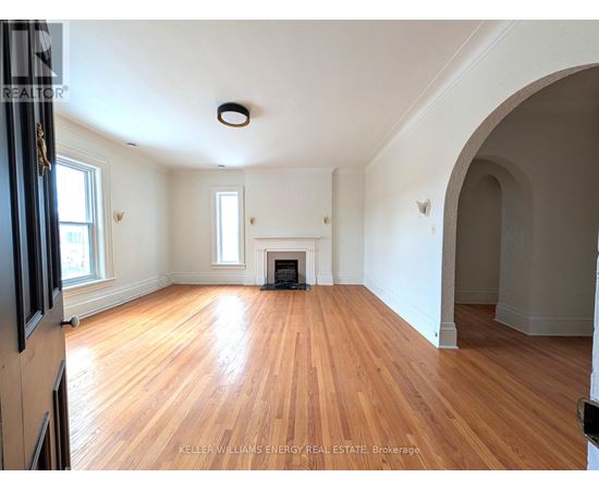 A room with wooden floors and a fireplace.