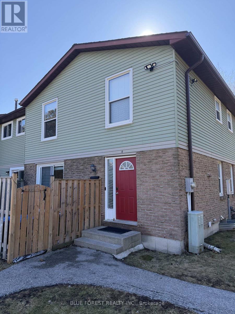 A house with a red door and a brown fence.