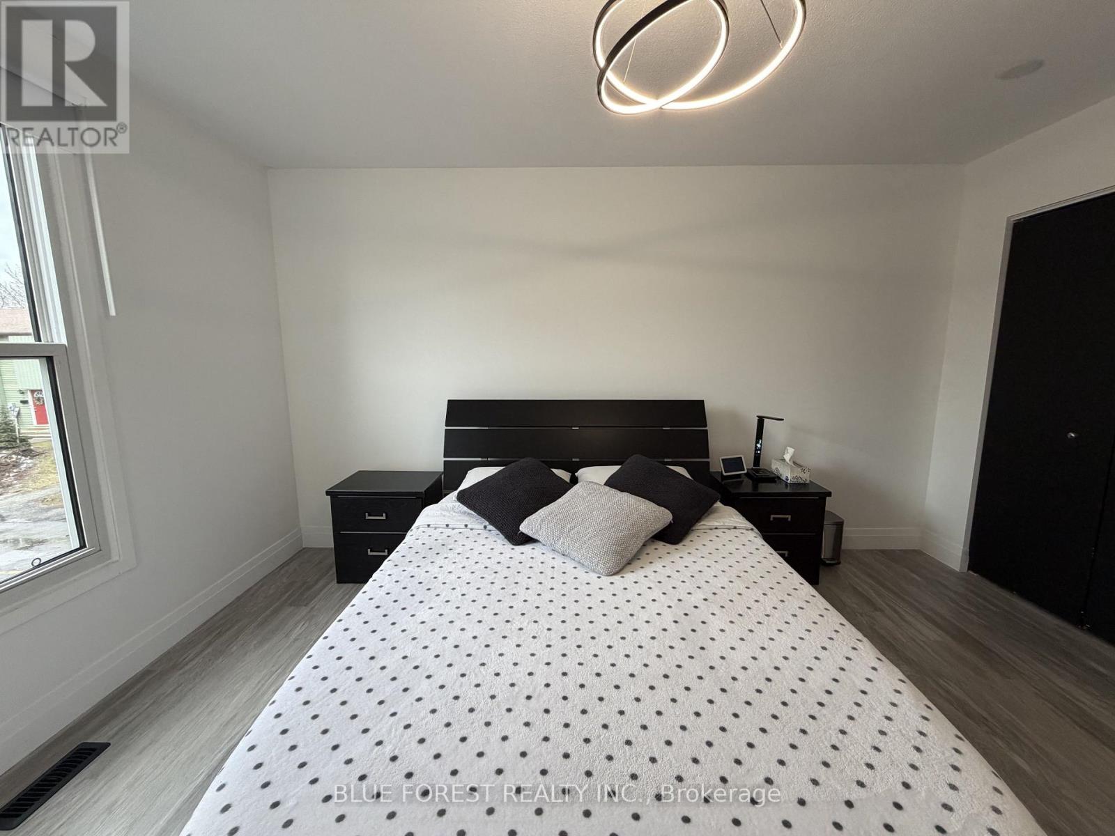 A bedroom with a large bed and a window.