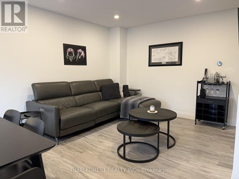 A living room with a grey sofa and a black coffee table.