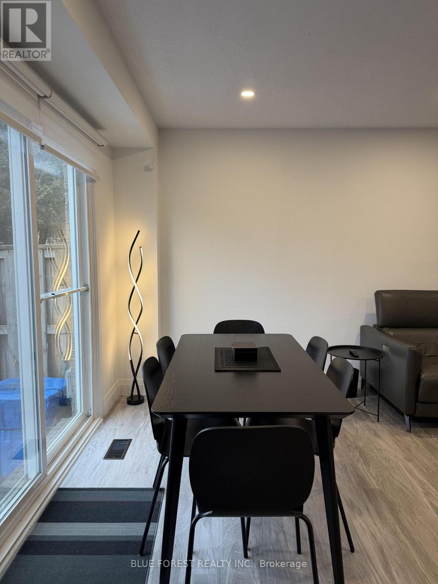 A dining room with a table and chairs.