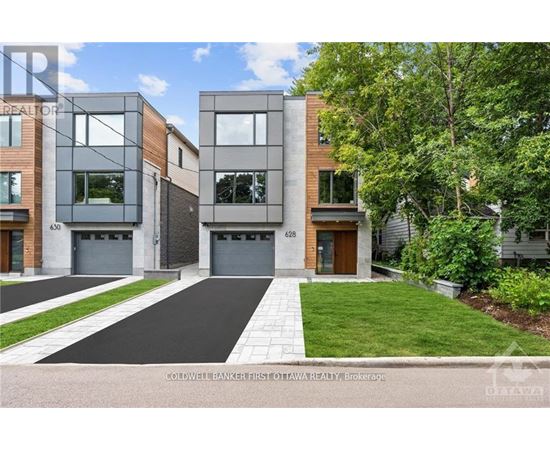 A modern two-story townhouse with a garage is for sale.