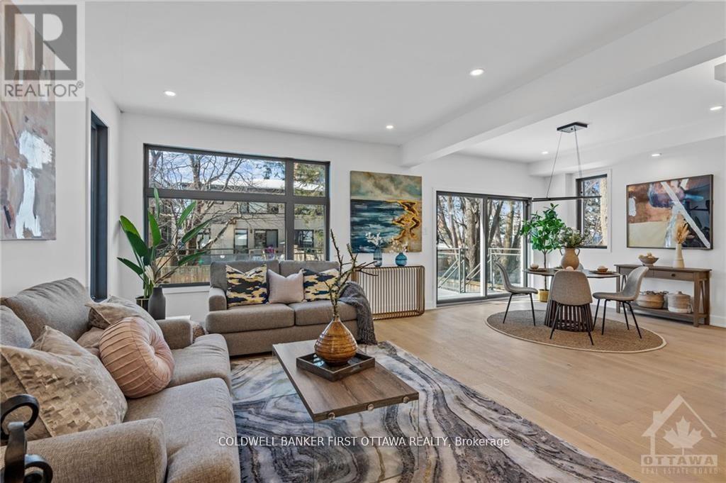 A living room with a couch, a coffee table, and a painting on the wall.