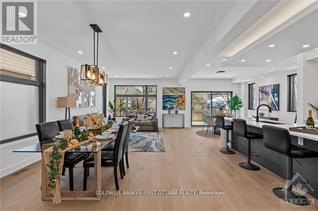 A modern dining room with a wooden table and chairs.