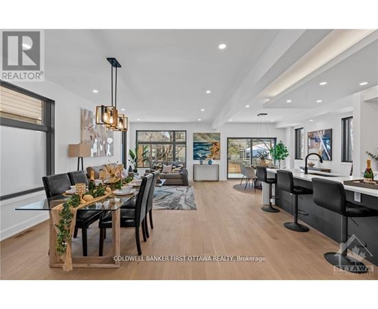 A modern dining room with a wooden table and chairs.