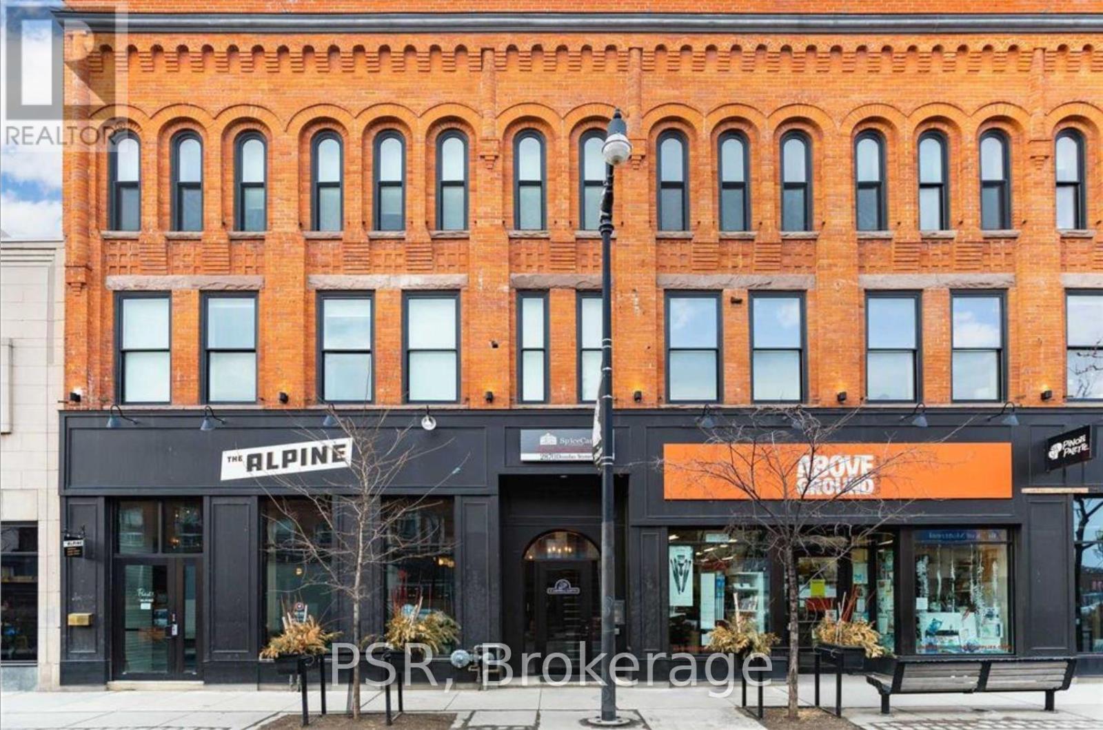 A red brick building with a black awning that says Alpine.