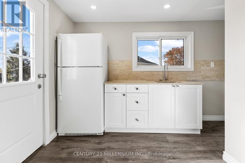 A kitchen with white appliances and cabinets is shown.