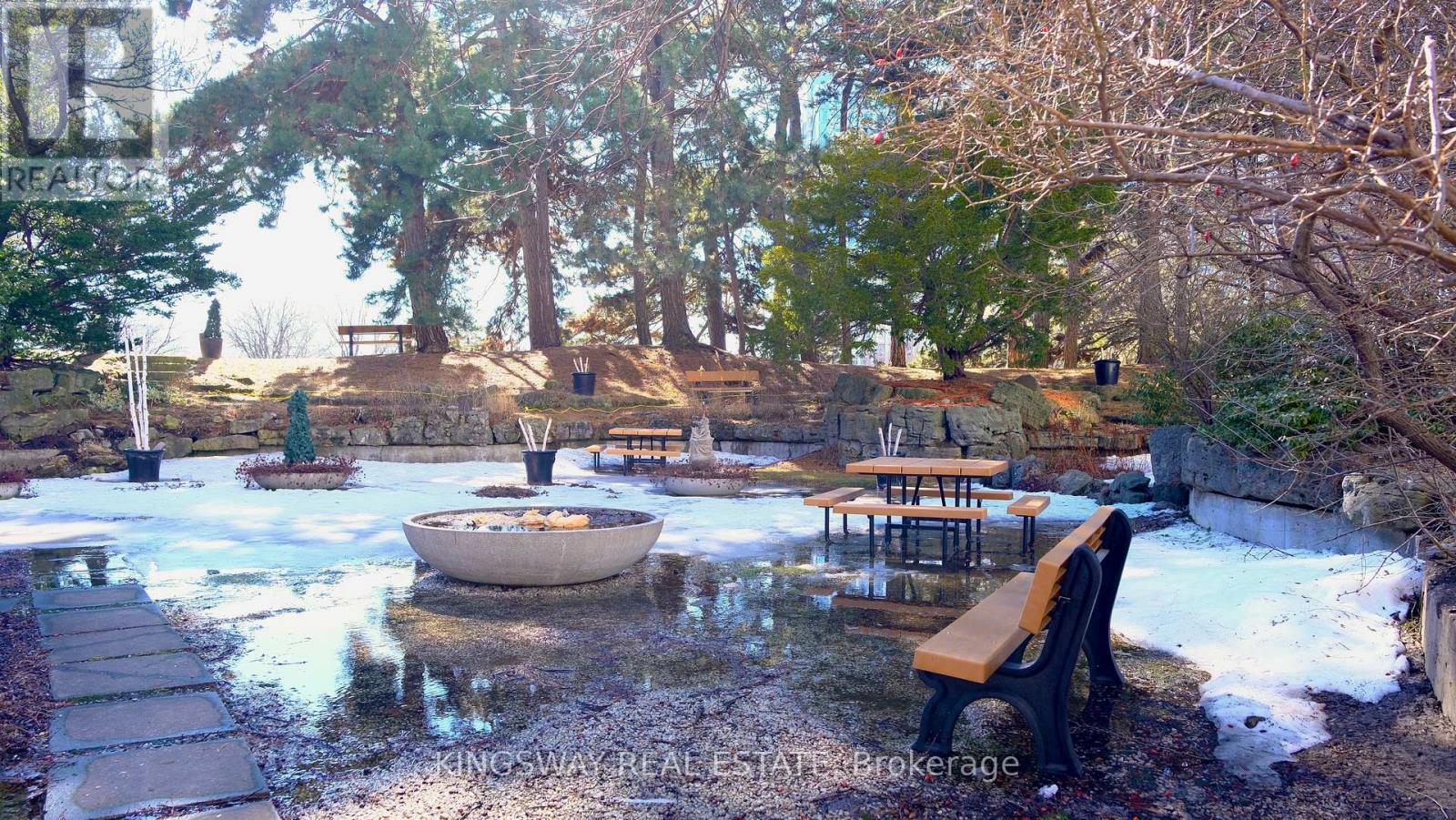 A hot tub in a backyard surrounded by trees.