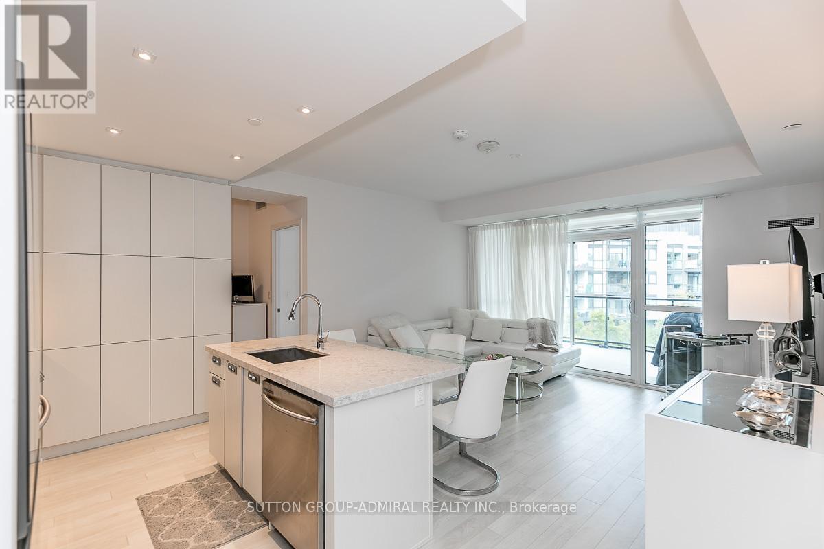 A modern kitchen with white cabinets and a large island.