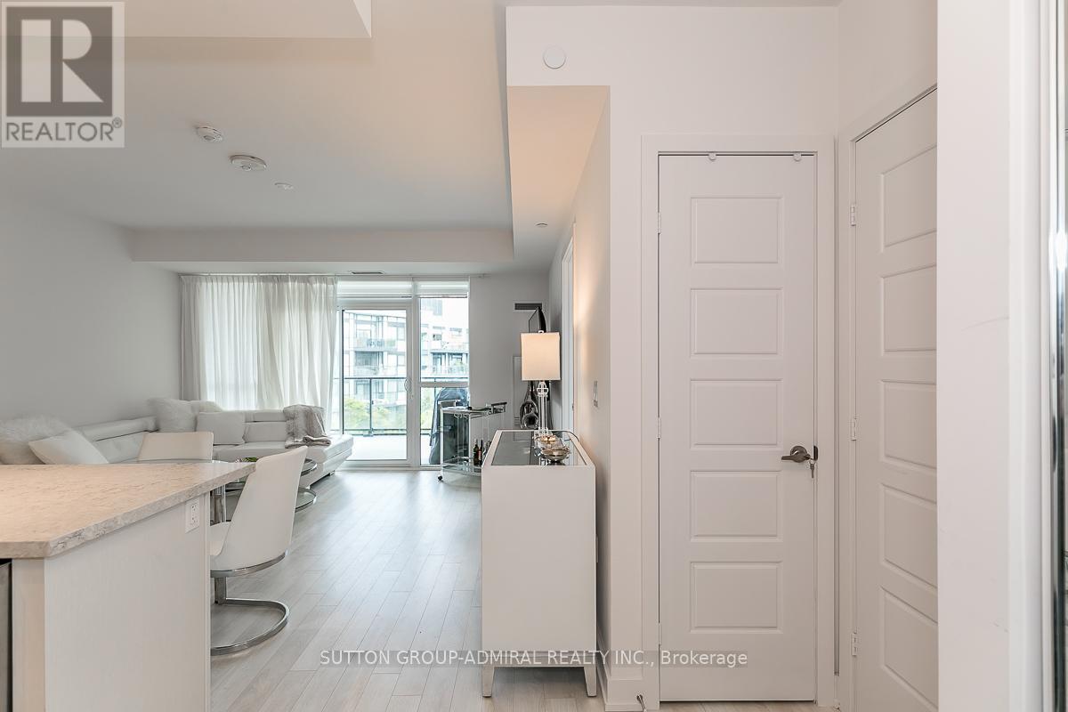 A white interior of a house with a kitchen and living room.