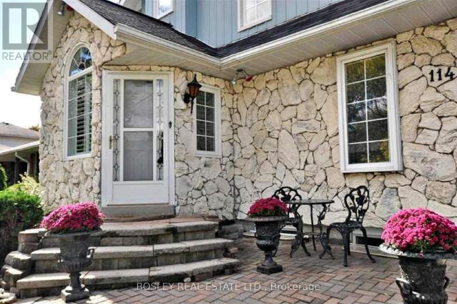 A house numbered 114 with a white door and windows.