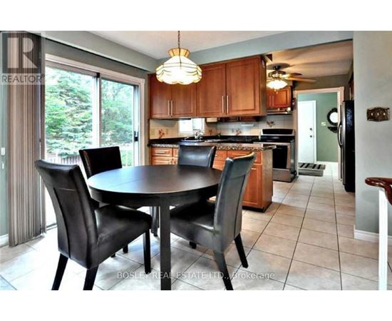 A kitchen with a table and chairs in the middle of the room.