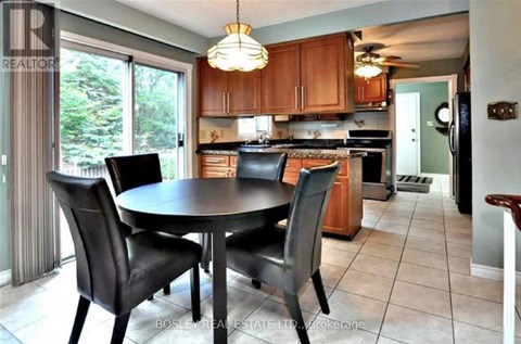 A kitchen with a table and chairs in the middle of the room.