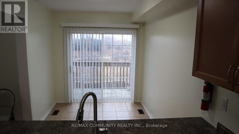A kitchen area with a sink and a window.