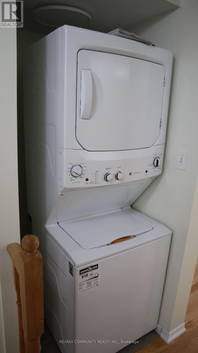 A white dryer is sitting in a small room.