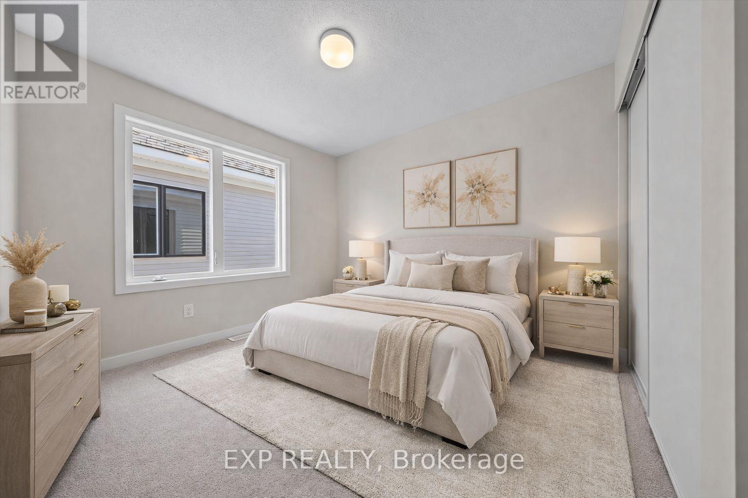 A bedroom with a bed, nightstands, and a window.