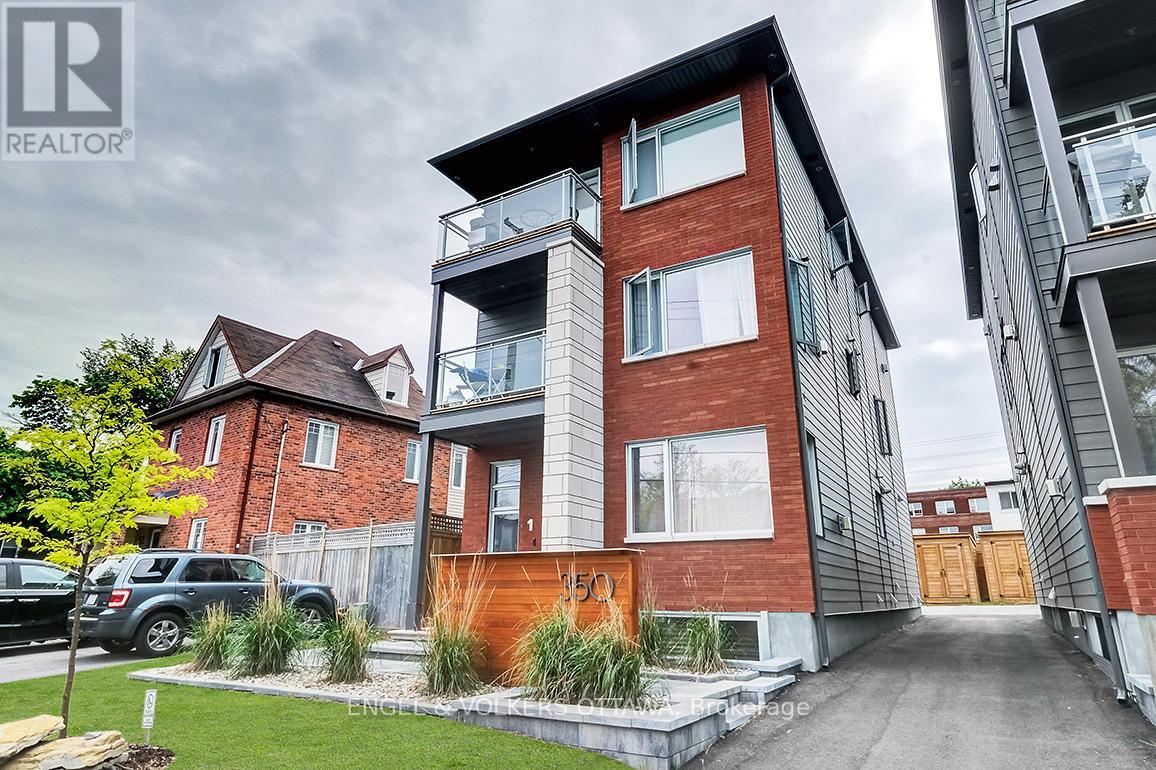 A modern two-story building with a balcony on the second floor.