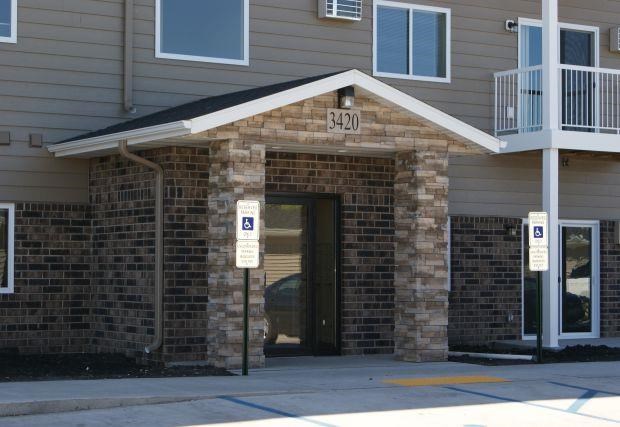 a brick building with a door and street signs