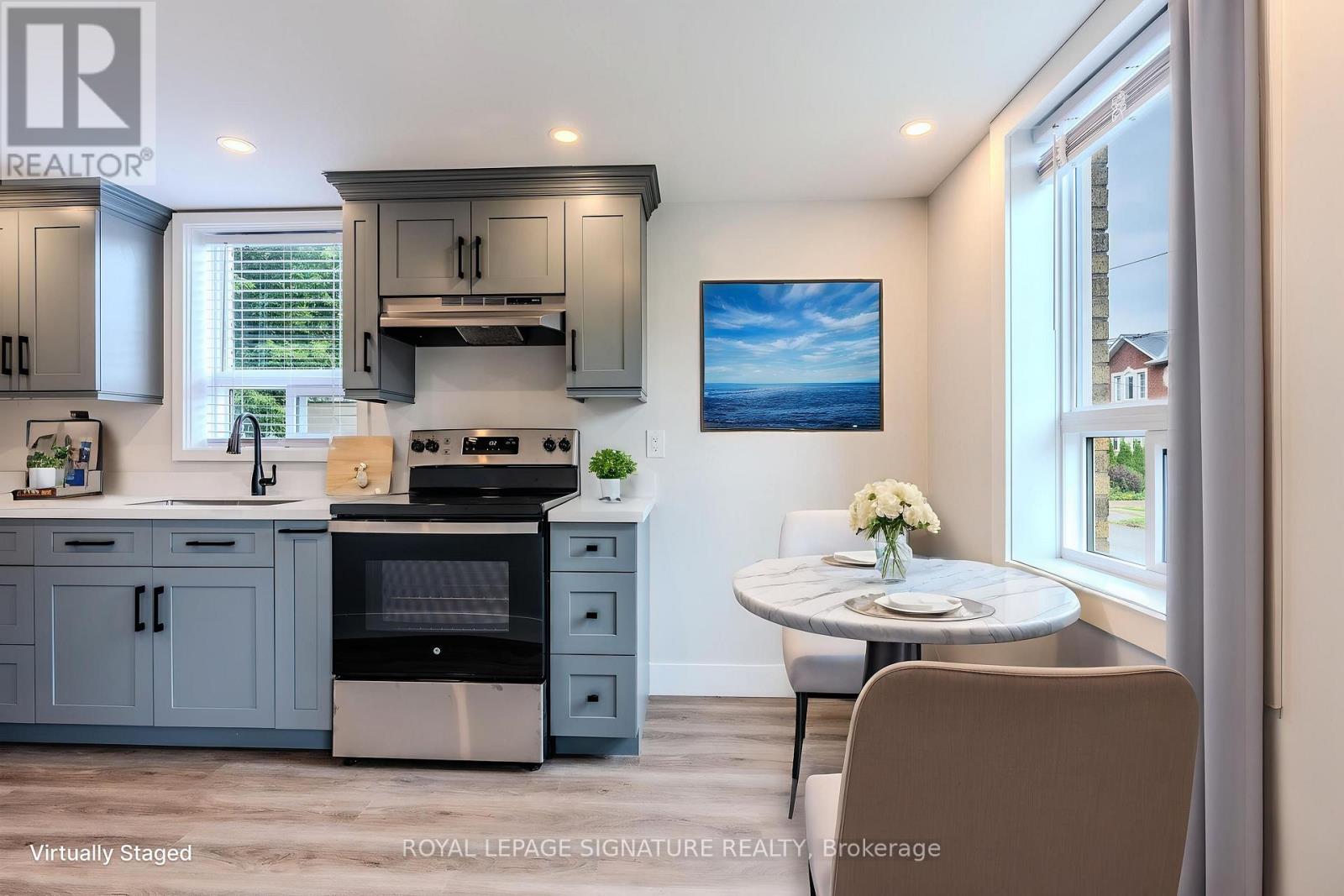 A modern kitchen with a dining table set for two.