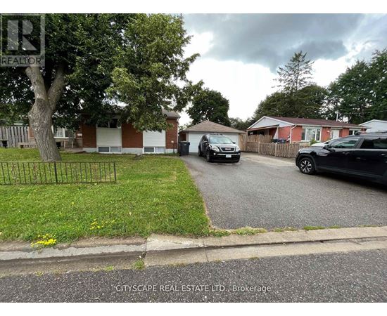A residential street with houses and parked cars.
