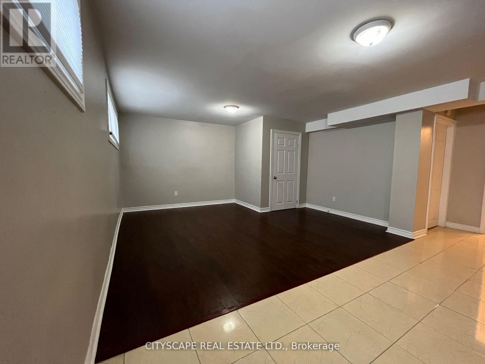 A spacious room with a door and a window.