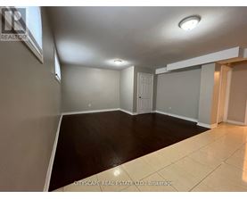 A spacious room with a door and a window.