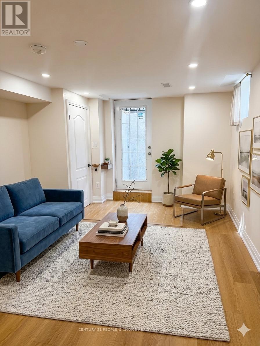 A living room with a blue couch, a wooden coffee table, and a rug.